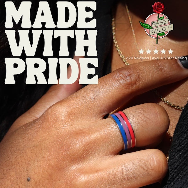 close up photo of a hand wearing a bisexual pride ring