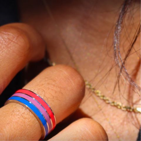 bisexual pride ring on middle finger girl holding hand on her collar