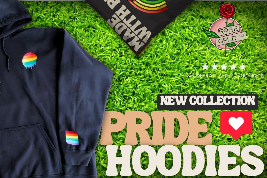 LGBT Rainbow Gay Pride Hoodie laying in grass with rose gold co logo and New collection pride hoodies 