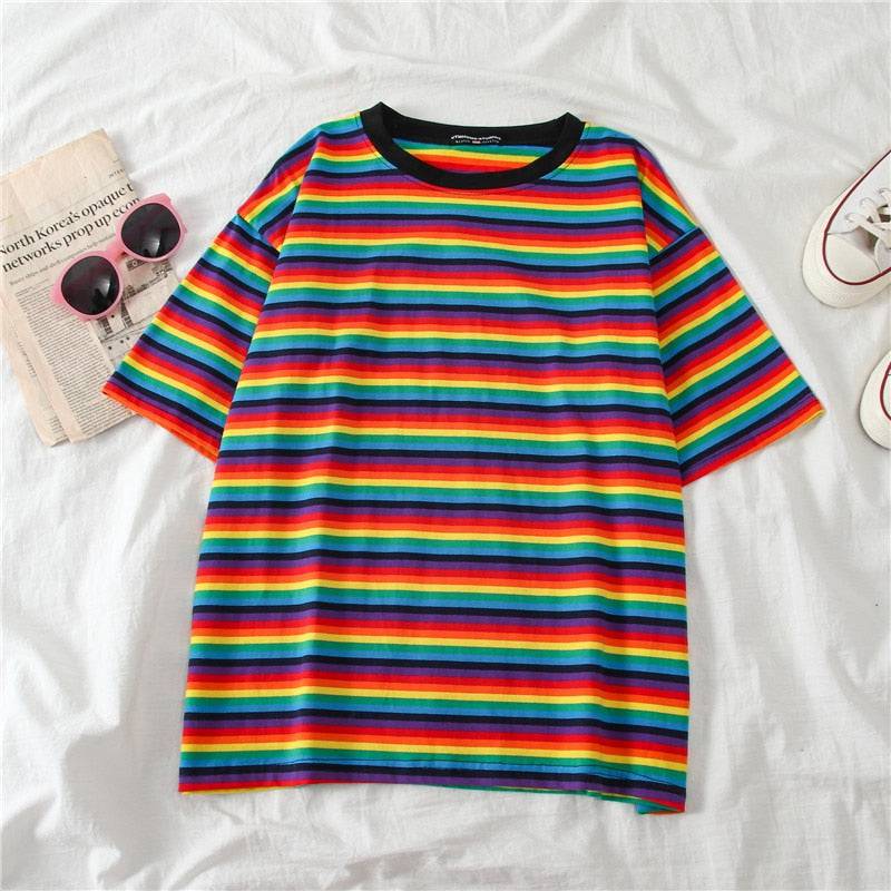 Rainbow and black collar shirt laying on a bed